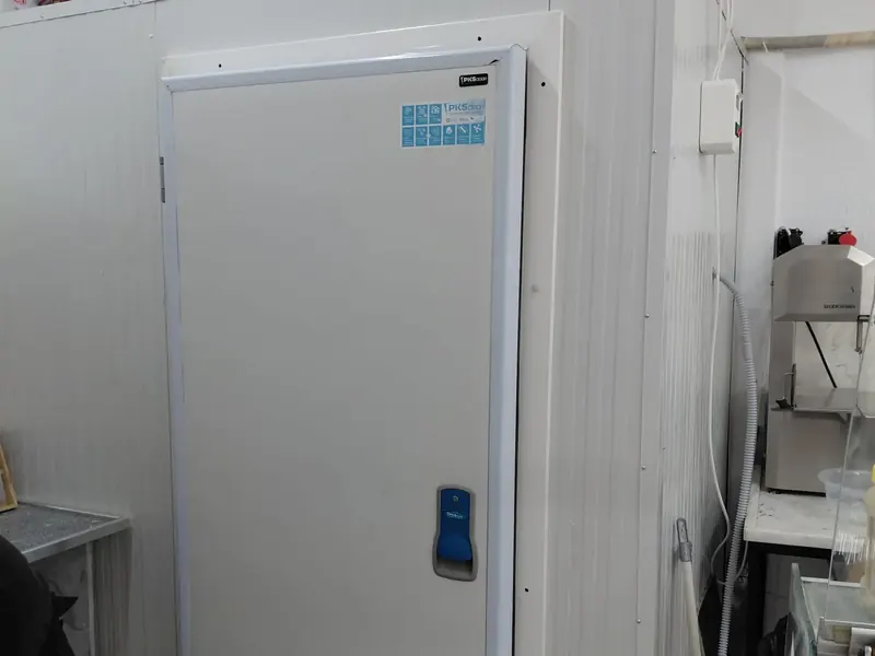 A cold room and its door, installed inside a business
