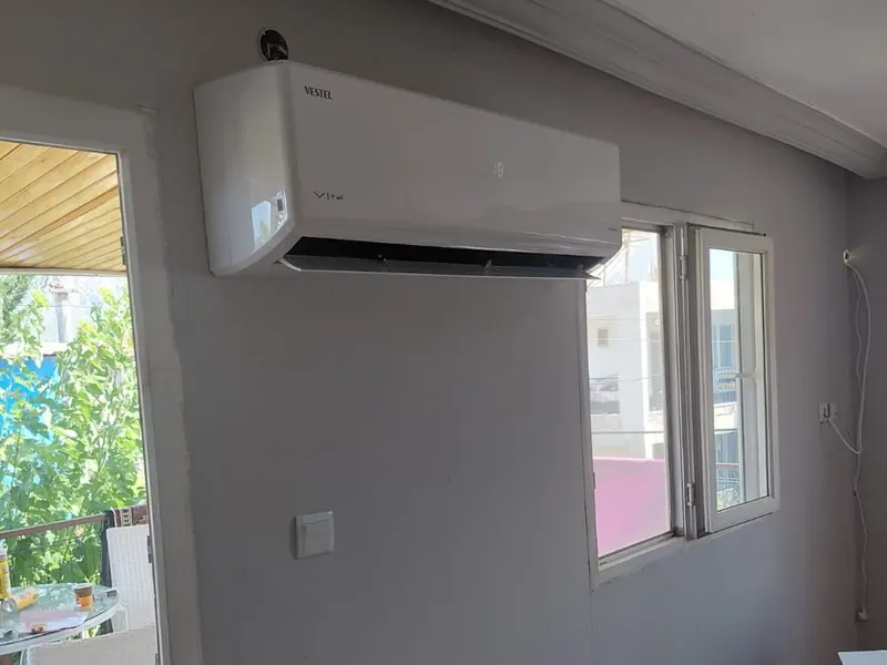 White indoor air conditioning unit mounted on a room wall